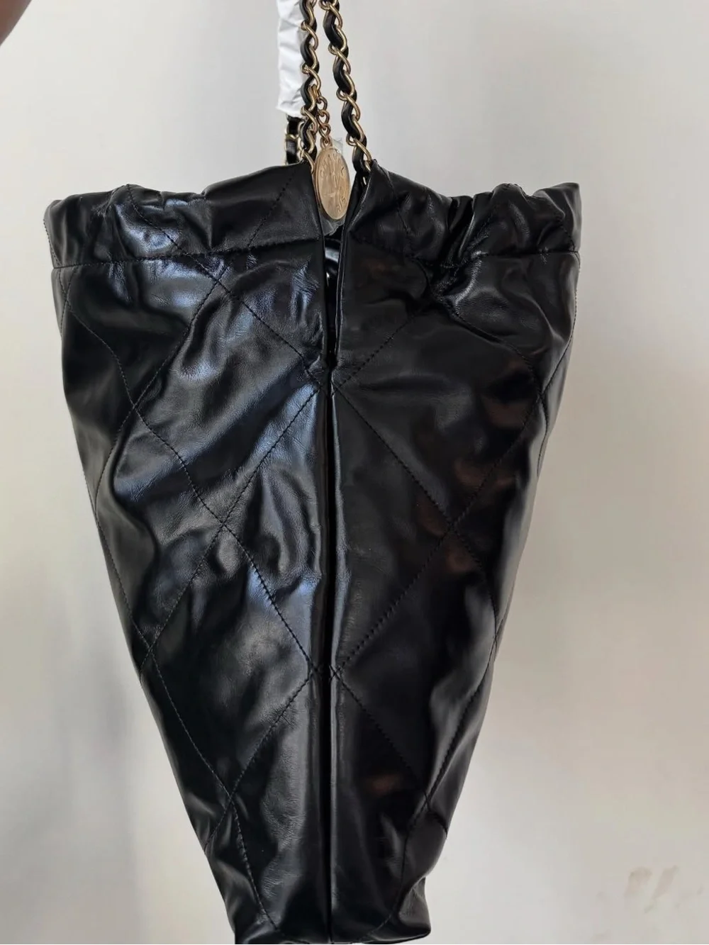 CHANEL Black Quilted Shoulder Bag with Gold Chain and Logo Charm